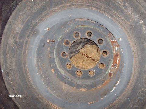 1990 Ford F-150 - A close-up view of a rusty wheel and tire assembly, likely from a 1990 Ford F-150, with a date stamp of 26/08/2008 visible.
