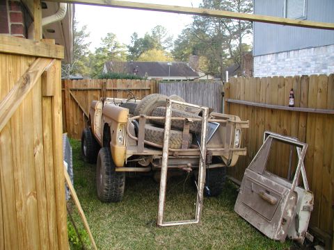 1971 Ford Bronco - This 1971 Ford Bronco is seen in a backyard with spare tires loaded in the bed and a detached door nearby.