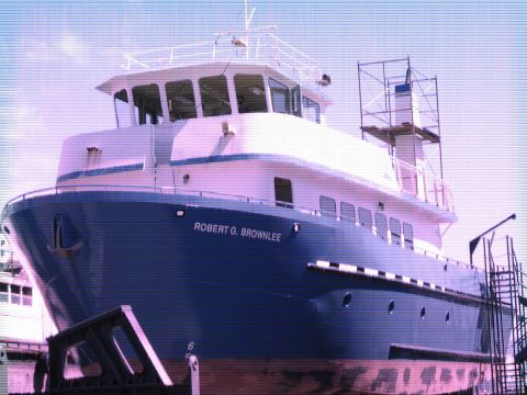 1991 Ford Bronco - The bow of a large blue and white watercraft named "ROBERT G. BROWNLEE" is shown docked and possibly undergoing maintenance. Scaffolding is…