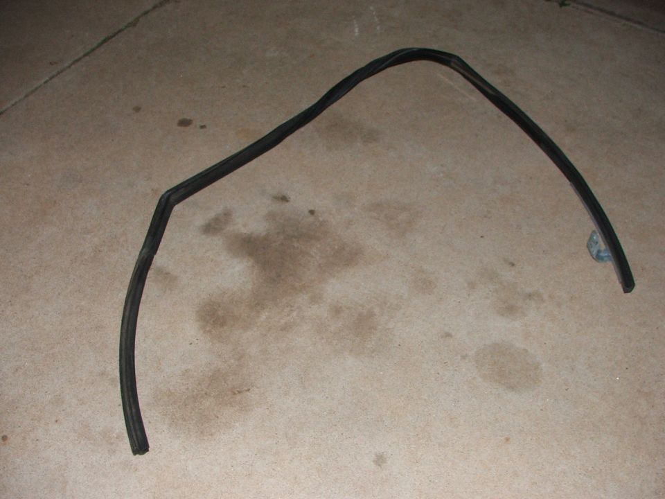 Black rubber weatherstripping seal on concrete