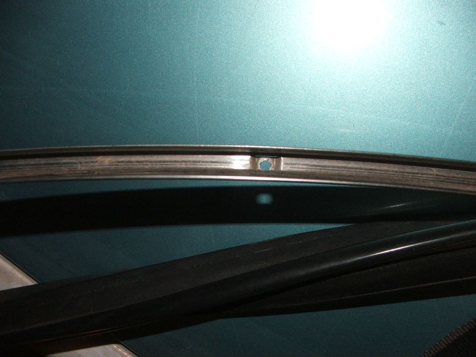 Close-up of a car rim with a hole.