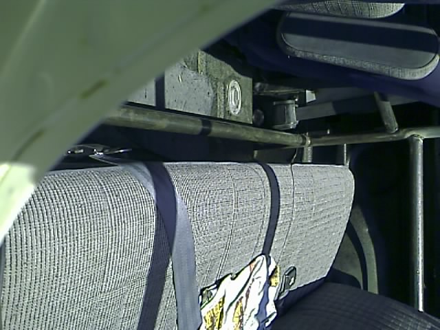 Interior of a vehicle showing a gray seat and blue seatbelt.