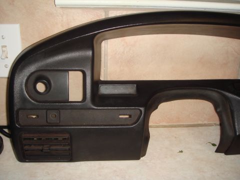 1992 Ford Bronco - This is a black dashboard component, possibly from a vehicle's interior, with no visible markings or year indicators.