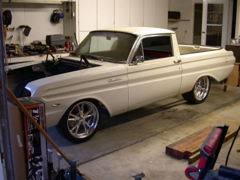 1964 Ford Ranchero - A white 1964 Ford Ranchero pickup truck is parked in a garage with its hood open, custom wheels.