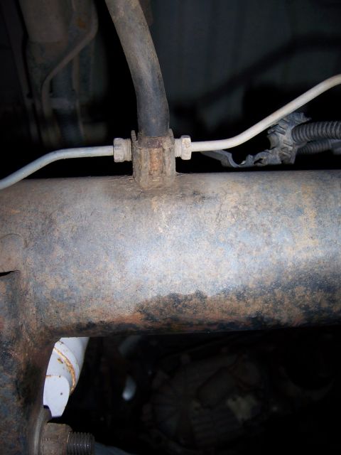 1991 Ford Bronco - Detail of brake lines connected to a vehicle's frame.