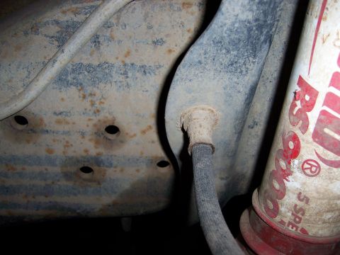 1991 Ford Bronco - Detail of a brake line and a shock absorber, possibly from a Ford Bronco.