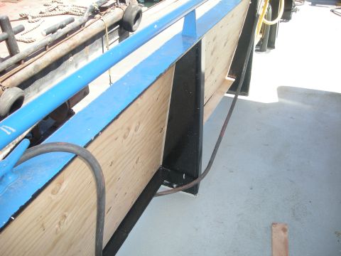 1991 Ford Bronco - A close-up view of a boat's deck, showing construction details and a blue railing.