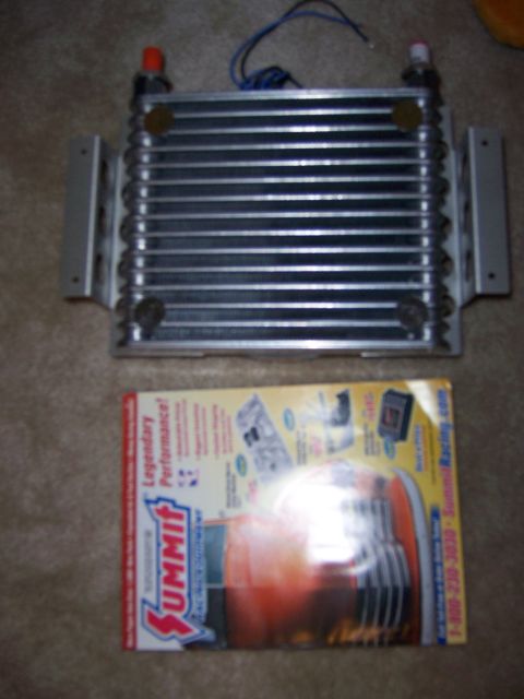 1991 Ford Bronco - A transmission cooler is shown next to a Summit Racing catalog, which features performance parts and contact information.