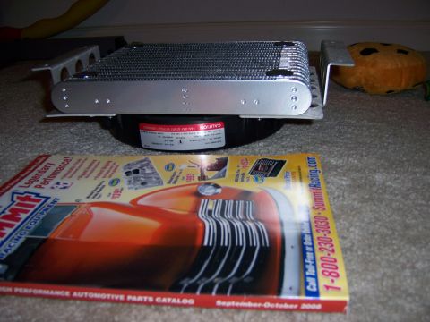 1991 Ford Bronco - A transmission cooler sits on top of a Summit Racing Equipment catalog.