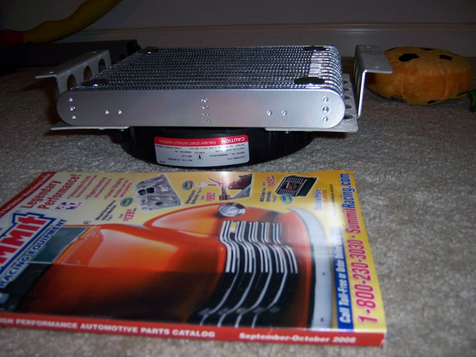 Transmission cooler with mounting brackets and a Summit Racing Equipment catalog