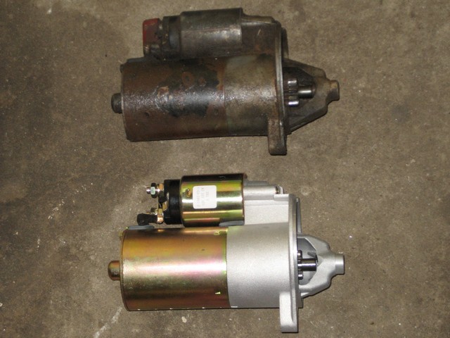 Old rusty starter motor above a new shiny starter motor