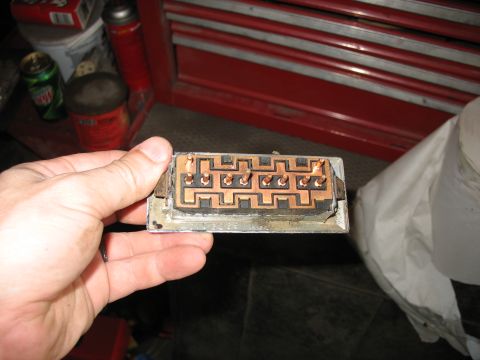 1988 Ford E250 - A hand holds an electrical connector part with multiple copper contacts visible.