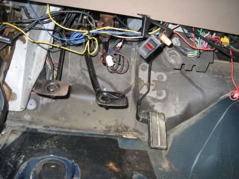 1995 Ford Bronco - The complex wiring and pedals are visible inside the vehicle's cabin.