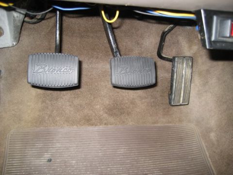 1995 Ford Bronco - Close-up of the floor pedals in a vehicle, with 'Bronco' visible on two of them.