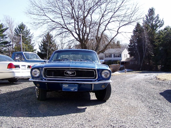 Blue 1968 Ford Mustang front view with Mustang emblem on grille