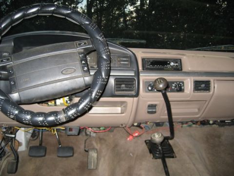 1995 Ford Bronco - The interior of a truck shows a manual transmission shifter and dashboard details.