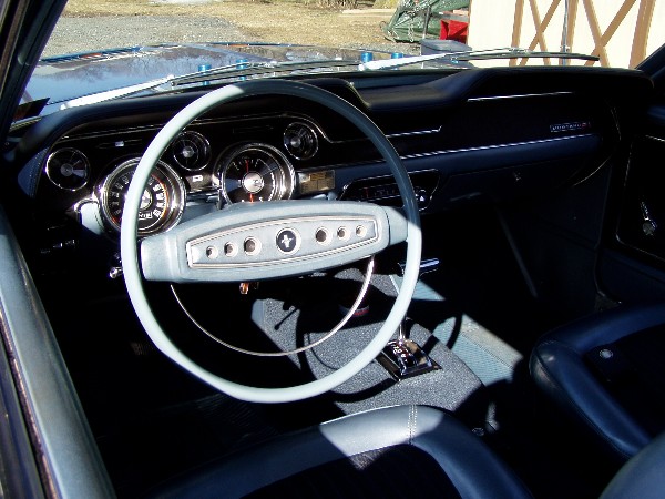 Interior view of a classic car dashboard and steering wheel