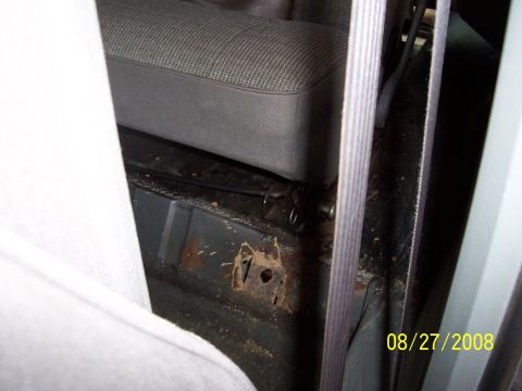 1988 Ford Bronco - Rust damage visible on the floor pan of a vehicle's interior, near the seat. The photo is dated 08/27/2008.