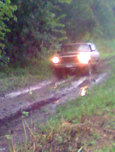 1979 Ford Bronco - 1979 Ford Bronco navigating a wet, off-road path.
