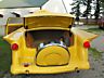 1953 Ford Mainline - A custom 1953 Ford Mainline is shown from the rear with its trunk open, revealing a spare tire.