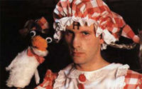 1976 Ford Ranchero - A man dressed in a costume with a puppet is shown against a dark background.