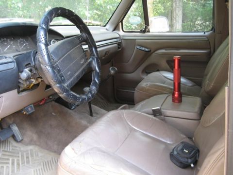 1995 Ford Bronco - Interior view of a 1995 Ford Bronco, the dashboard, steering wheel, and seating areas.