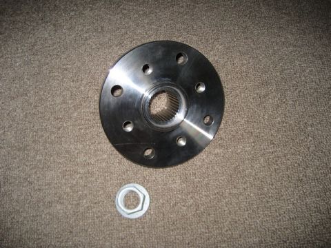 1995 Ford Bronco - A metal flange and nut are shown against a carpeted background.