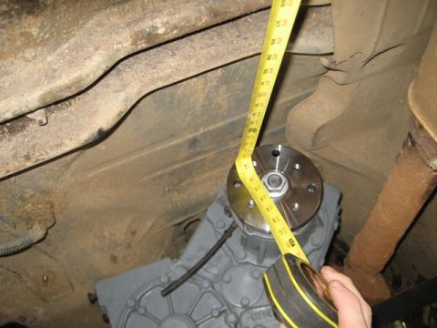 1995 Ford Bronco - A close-up view of a vehicle's undercarriage, focusing on the transfer case and exhaust system.