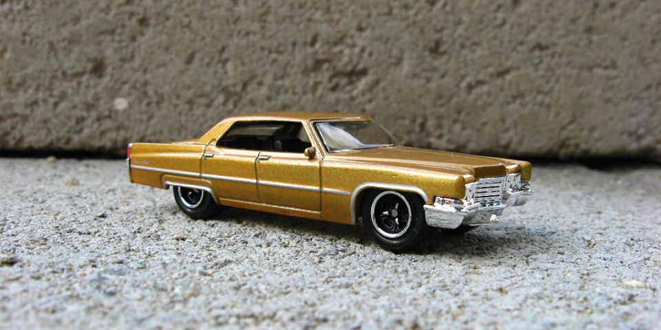 Side profile of a gold die-cast Cadillac four-door hardtop model
