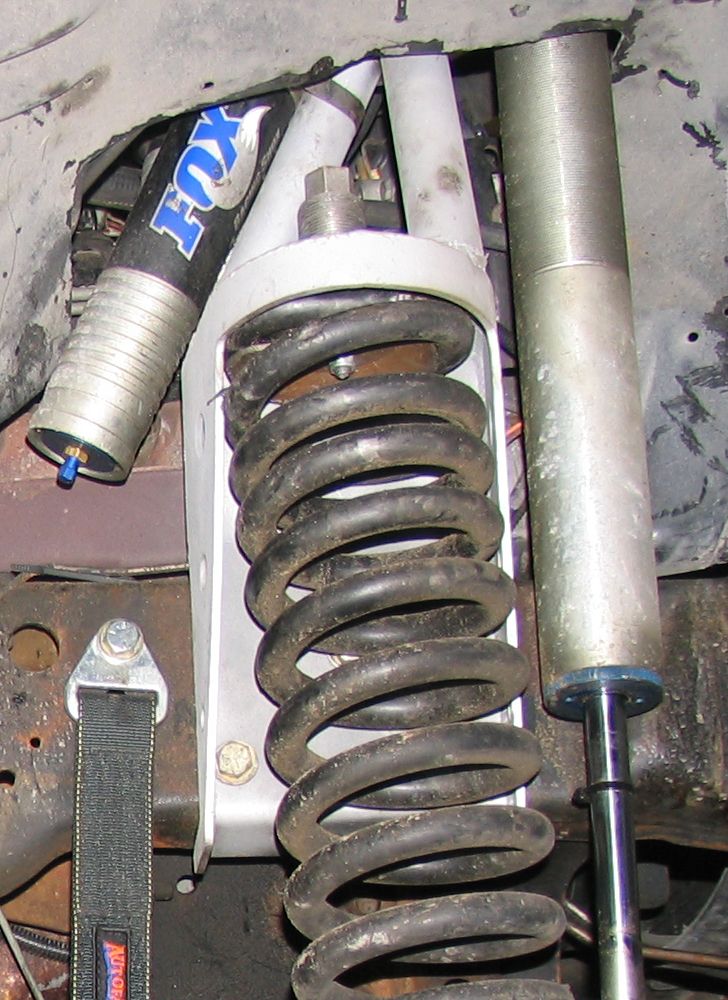 Close-up of a Fox shock absorber and coil spring assembly, likely for off-road use