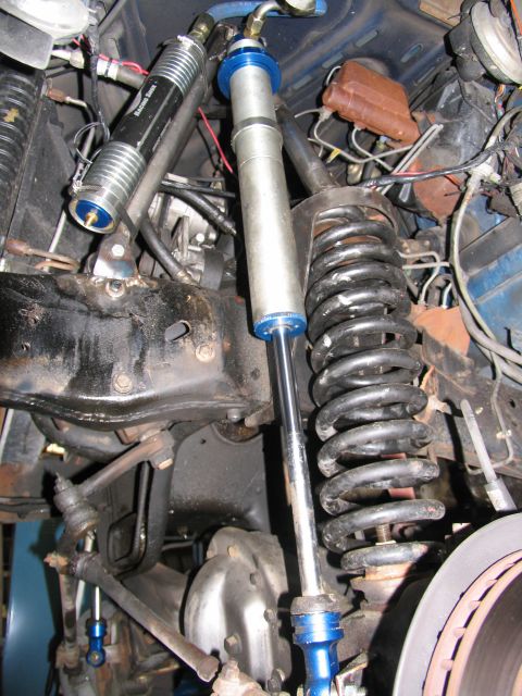 1984 Ford Bronco - The image shows aftermarket suspension components, including coil springs and shock absorbers, with visible branding on one shock.