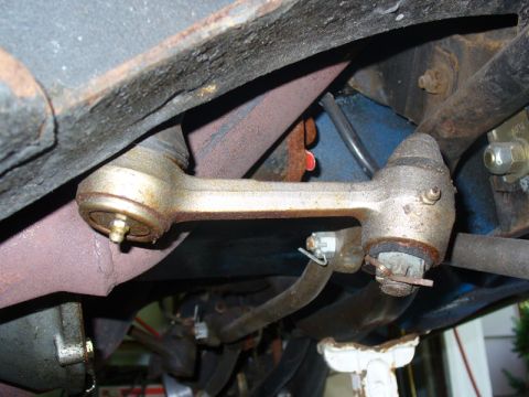 1968 Ford Mustang - Close-up of aged vehicle undercarriage components, showing rust and wear on suspension and exhaust systems.