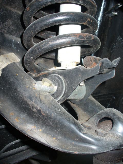 1968 Ford Mustang - Detail of a vehicle's suspension system, showing a coil spring and shock absorber assembly.