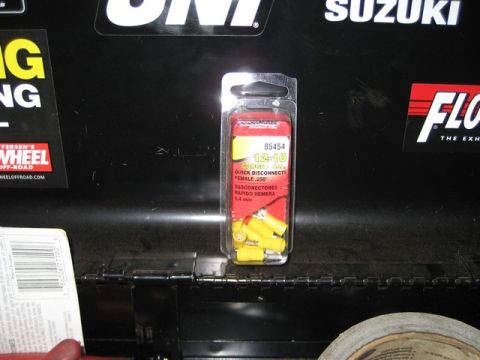 1995 Ford Bronco - A package of electrical disconnects is shown against a black background with various stickers.