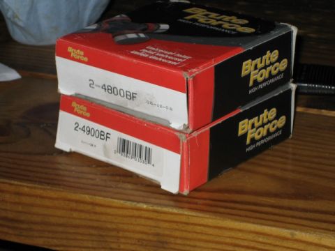 1995 Ford Bronco - Two boxes of Brute Force high performance parts are stacked on a wooden surface.