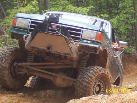 1978 Ford Bronco - This modified truck, likely from the 1980s, navigates a rocky trail with its front end lifted.