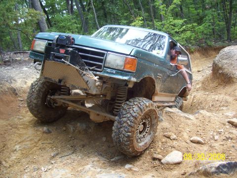 1978 Ford Bronco - Ford Bronco tackling a challenging off-road course on a sunny day.