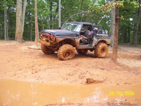 1978 Ford Bronco - This modified 1978 Ford Bronco appears to be stuck in a muddy off-road trail.