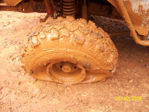 1978 Ford Bronco - Mud-stuck tire with visible suspension and bodywork, dated 08/30/2008.