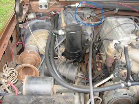 1988 Ford Bronco - Close-up view of engine bay components, including hoses, wiring, and horns.