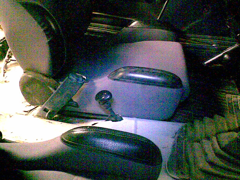 Removed side mirrors, shift lever and seat belt buckle in dim light