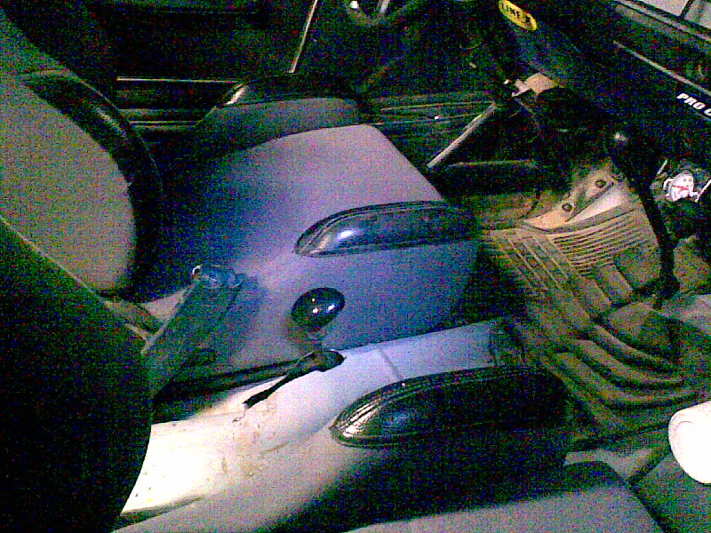 Removed gray side mirrors, shift lever and seat belt buckle on a bench