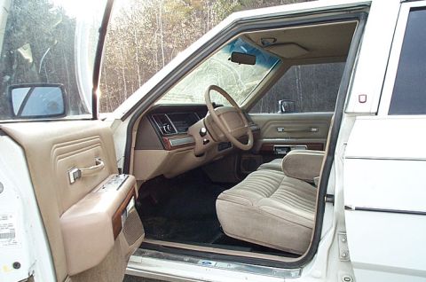 1991 Ford LTD Crown Victoria - The interior of a 1991 Ford Crown Victoria LTD is visible, tan upholstery and the dashboard.