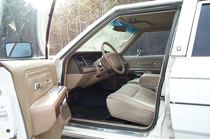 Interior of a 1991 Ford Crown Victoria LTD, showing tan seats and dashboard