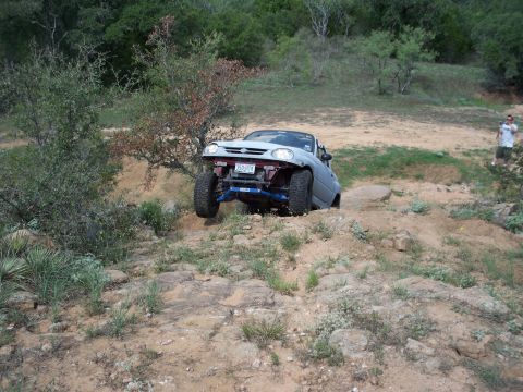 1996 Ford Bronco - Off-road vehicle with custom suspension tackling challenging terrain.