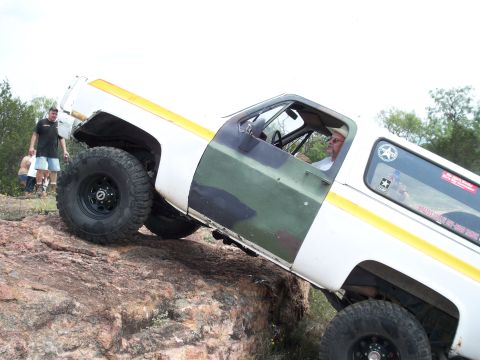 1996 Ford Bronco - This vehicle appears to be a 1973 Chevrolet K5 Blazer, not a 1996 Ford Bronco, as it navigates rocky terrain.