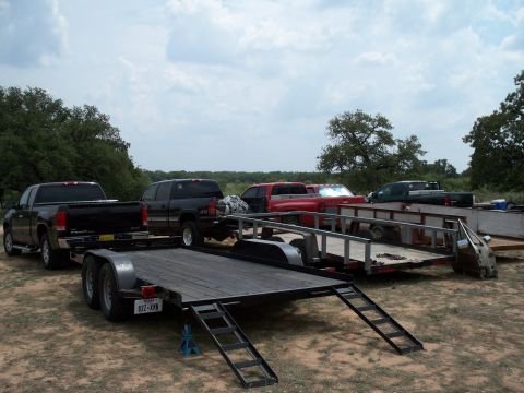 1996 Ford Bronco - Multiple trucks and trailers are parked in an outdoor lot.