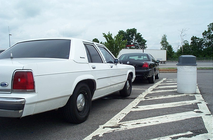 White 1991 Ford Crown Victoria LTD sedan, rear view, parked in a lot