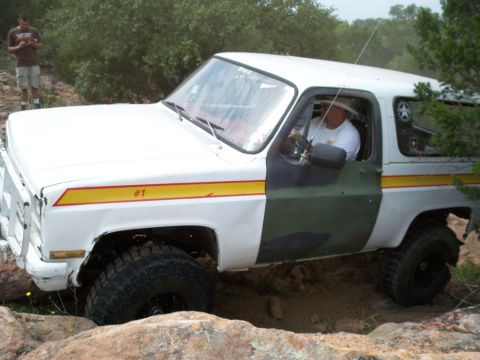 1996 Ford Bronco - This off-road SUV, likely from the 1970s, navigates a rocky trail.