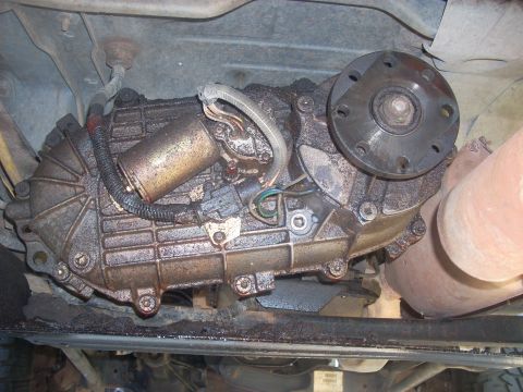 1992 Ford Bronco - Underside view of a vehicle's transfer case, showing its components and connections.